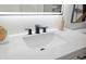 White bathroom vanity with black matte faucet and countertop at 6291 Bahia Del Mar Cir # 103, St Petersburg, FL 33715