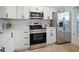 Updated kitchen featuring stainless steel appliances and white shaker cabinets at 6291 Bahia Del Mar Cir # 103, St Petersburg, FL 33715