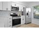 Modern kitchen with stainless steel appliances and white cabinets at 6291 Bahia Del Mar Cir # 103, St Petersburg, FL 33715