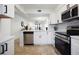 Modern white kitchen with stainless steel appliances and island at 6291 Bahia Del Mar Cir # 103, St Petersburg, FL 33715