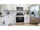 Modern kitchen with stainless steel appliances and white cabinets at 6291 Bahia Del Mar Cir # 103, St Petersburg, FL 33715