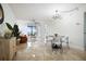 Bright living room and dining area with water views and modern chandelier at 6291 Bahia Del Mar Cir # 103, St Petersburg, FL 33715