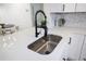 Modern kitchen sink with black faucet and white quartz countertops at 6291 Bahia Del Mar Cir # 103, St Petersburg, FL 33715