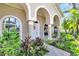 Front entrance with arched entryway, columns, and landscaping at 4514 Gentrice Dr, Valrico, FL 33596