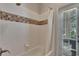 Bathroom with tub, shower, and mosaic tile accents at 4514 Gentrice Dr, Valrico, FL 33596