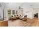 Living area featuring an L-shaped sofa and a view to the kitchen at 30443 Lynne Dr, Wesley Chapel, FL 33543