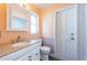 Clean bathroom with a vanity, toilet and a door at 1001 Chinaberry Rd, Clearwater, FL 33764