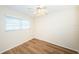 Well-lit bedroom featuring wood-look floors and window blinds at 1001 Chinaberry Rd, Clearwater, FL 33764