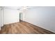 Bedroom with wood-look floors and access to bathroom at 1001 Chinaberry Rd, Clearwater, FL 33764