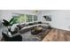 Bright living room featuring a comfy sectional sofa and large windows at 1001 Chinaberry Rd, Clearwater, FL 33764
