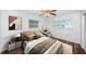 Bedroom with wood-look floors, two windows, and a ceiling fan at 1001 Chinaberry Rd, Clearwater, FL 33764