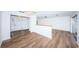 Open living area with hardwood floors and a half wall partition at 1001 Chinaberry Rd, Clearwater, FL 33764