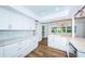 Bright kitchen with white cabinets and granite countertops at 1001 Chinaberry Rd, Clearwater, FL 33764