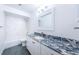 Updated bathroom with granite countertop and white cabinetry at 1001 Chinaberry Rd, Clearwater, FL 33764