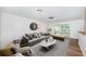 Living room features grey sofa and access to a relaxing patio at 1001 Chinaberry Rd, Clearwater, FL 33764