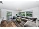 Relaxing living area with grey sectional sofa and access to patio at 1001 Chinaberry Rd, Clearwater, FL 33764
