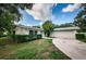 Light-colored house with attached garage and neatly trimmed hedges at 1001 Chinaberry Rd, Clearwater, FL 33764
