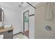Bathroom features a shower with a glass door and vanity with stylish fixtures at 233 W College Ave, Ruskin, FL 33570