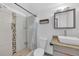 Modern bathroom featuring tiled shower and vanity with stylish fixtures at 233 W College Ave, Ruskin, FL 33570