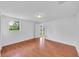 Bedroom featuring hardwood floors, a window and an open door to the outside at 233 W College Ave, Ruskin, FL 33570