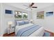 Comfortable bedroom with a bed, blue accents, and natural light from the windows at 233 W College Ave, Ruskin, FL 33570
