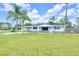 Charming single story home featuring a covered carport and well maintained lawn at 233 W College Ave, Ruskin, FL 33570