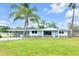 Charming single story home featuring a covered carport and well maintained lawn at 233 W College Ave, Ruskin, FL 33570