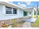 Inviting home entrance with stone accents and a covered front porch area at 233 W College Ave, Ruskin, FL 33570