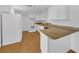 Clean, well-lit kitchen features white cabinets and a functional layout at 233 W College Ave, Ruskin, FL 33570