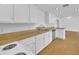 Well-lit kitchen featuring granite countertops and ample cabinet space at 233 W College Ave, Ruskin, FL 33570