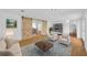 Spacious living room with wooden floors, barn doors, and stylish furniture at 233 W College Ave, Ruskin, FL 33570