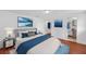 Comfortable bedroom with blue accents and ensuite bathroom access at 233 W College Ave, Ruskin, FL 33570