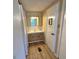 Small bathroom with wood cabinets and good storage at 2331 Belleair Rd # Lot 237, Clearwater, FL 33764