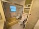 Accessible bathroom with a tub, handrails, and toilet at 2331 Belleair Rd # Lot 237, Clearwater, FL 33764