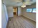 Bedroom with wood flooring, ceiling fan, and attached bathroom at 2331 Belleair Rd # Lot 237, Clearwater, FL 33764