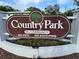 Welcoming Country Park 55+ community sign with manicured landscaping and clear signage at 2331 Belleair Rd # Lot 237, Clearwater, FL 33764