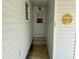 Exterior door showcasing a tidy entryway with a window, light fixture, steps, and thermometer under the roofline at 2331 Belleair Rd # Lot 237, Clearwater, FL 33764