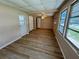 Living area with windows, wood flooring, and a ceiling fan at 2331 Belleair Rd # Lot 237, Clearwater, FL 33764