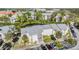 Aerial view of condo buildings, lush landscaping, and parking lot at 621 99Th N Ave # 102, St Petersburg, FL 33702