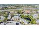 Aerial shot featuring condos near lush landscaping and a tranquil pond at 621 99Th N Ave # 102, St Petersburg, FL 33702