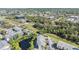 Expansive aerial view of community featuring lush greenery and pond at 621 99Th N Ave # 102, St Petersburg, FL 33702