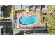 Aerial view of a kidney-shaped pool with lounge chairs and tables at 621 99Th N Ave # 102, St Petersburg, FL 33702