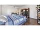 This bedroom boasts a large entertainment center and wood flooring at 621 99Th N Ave # 102, St Petersburg, FL 33702