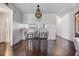 Dining room with wood floors, a modern chandelier, and open view into the kitchen at 621 99Th N Ave # 102, St Petersburg, FL 33702