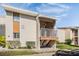 Condo exterior featuring a well-maintained facade, small patio, and manicured landscaping at 621 99Th N Ave # 102, St Petersburg, FL 33702