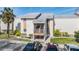 Two-story building with stairs leading to the second floor and covered parking at 621 99Th N Ave # 102, St Petersburg, FL 33702