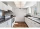 Bright kitchen features white cabinets, dark countertops, and a window for natural light at 621 99Th N Ave # 102, St Petersburg, FL 33702