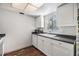 Bright kitchen features white cabinets, dark countertops, and a window for natural light at 621 99Th N Ave # 102, St Petersburg, FL 33702