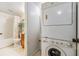This small laundry area features a stacked washer and dryer at 621 99Th N Ave # 102, St Petersburg, FL 33702