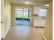 Kitchen features white cabinets, granite counters and sliding doors to the patio at 7335 Buchanan Dr, Port Richey, FL 34668